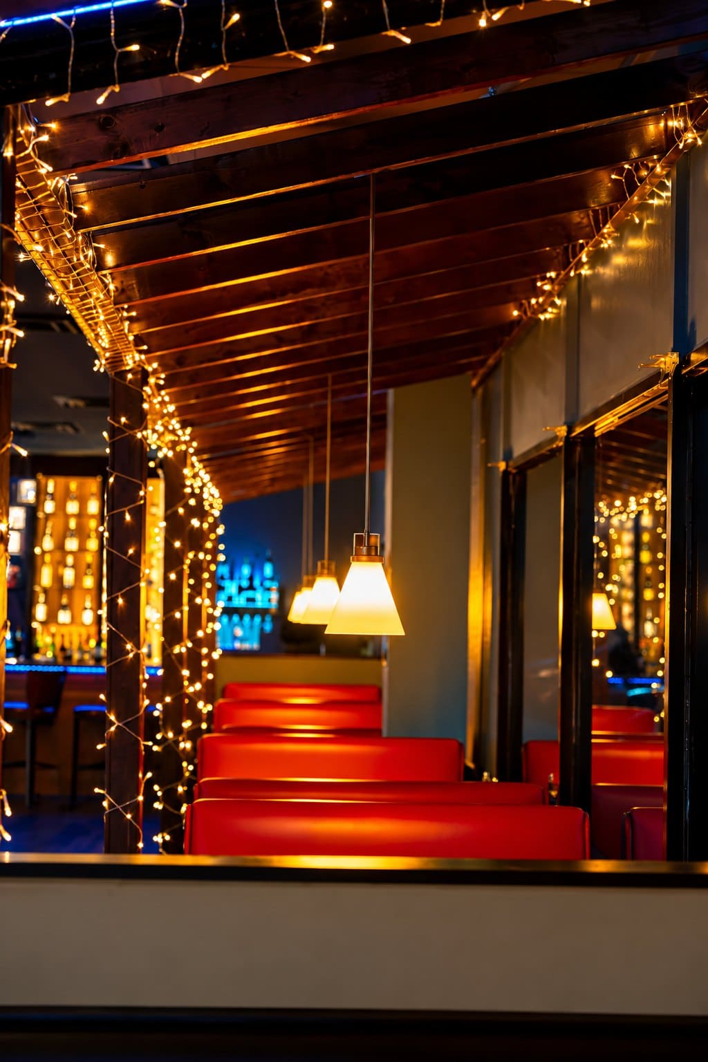 Red booths under string lights