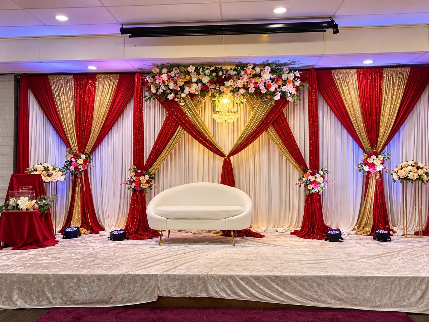 A banquet stage in maroon and gold